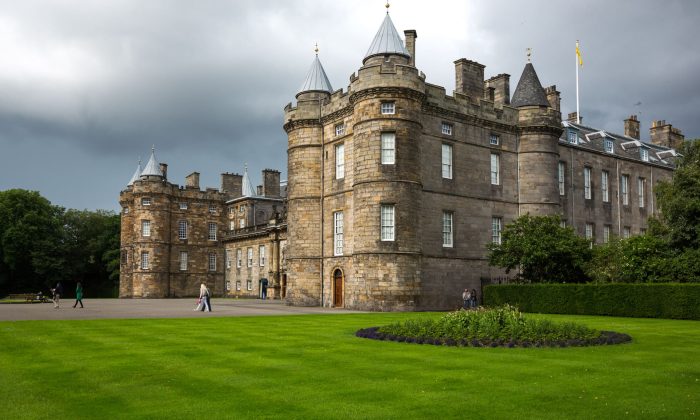 Edinburgh, United Kingdom - July 28, 2012: Visitor swalking in the forecourt in front of the main entrance of the Holyroodhouse Palace